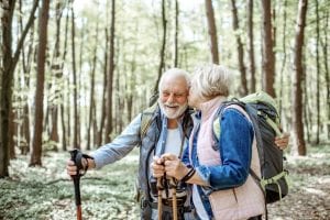 senior couple hiking with backpacks