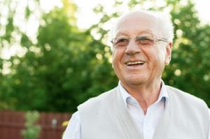 closeup profile of a smiling senior man