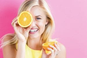 smiling woman with an orange