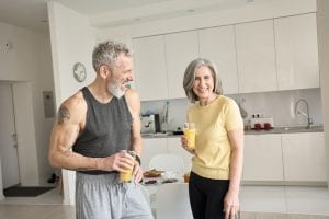 healthy senior adults laughing and drinking juice