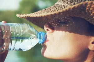 woman drinking water outside