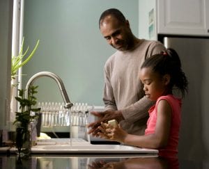 father and daughter doing the dishes