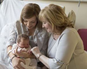 mom and grandmother with new born baby
